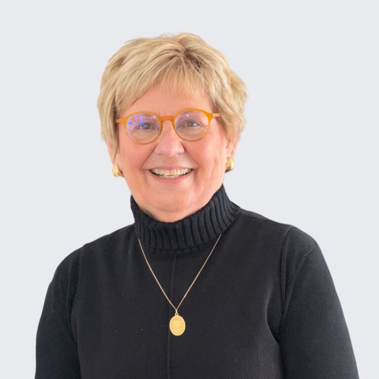 Mary Wuebben, PA-C, a certified physician assistant specializing in functional medicine, wearing a black turtleneck and gold accessories, smiling warmly.