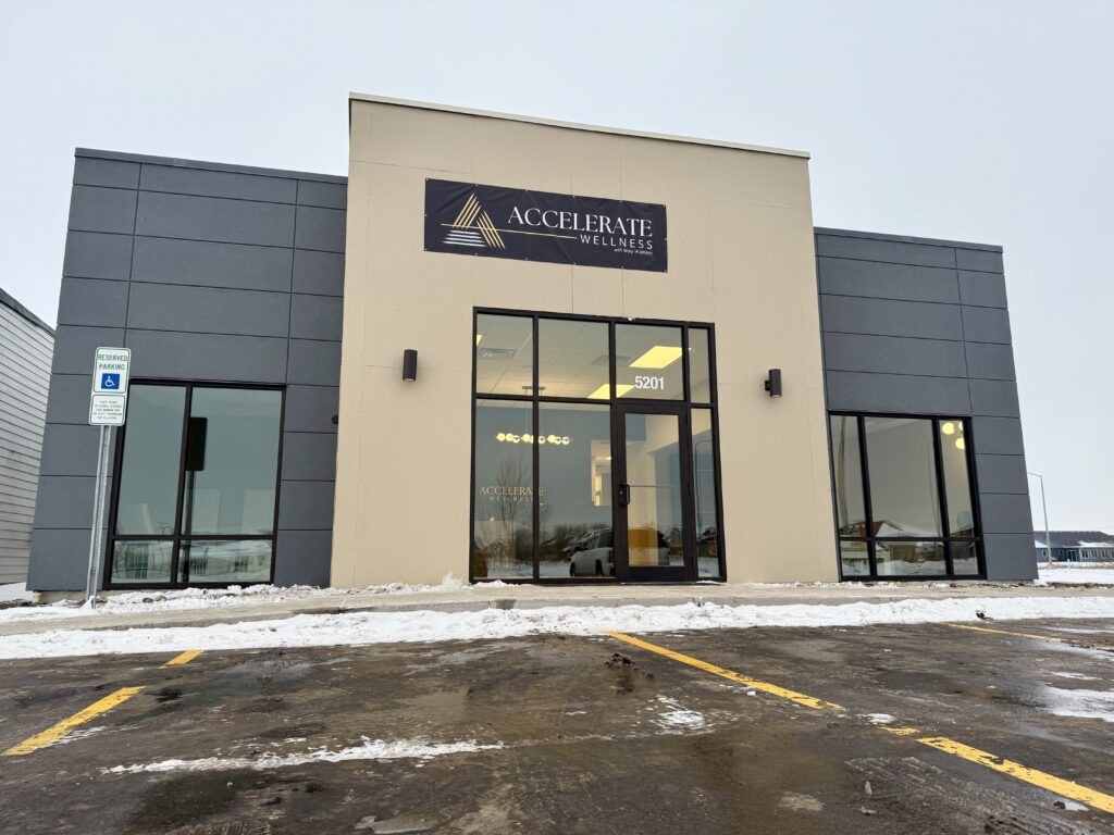 Full view of the Accelerate Wellness clinic exterior with its modern facade, large windows, and entrance.